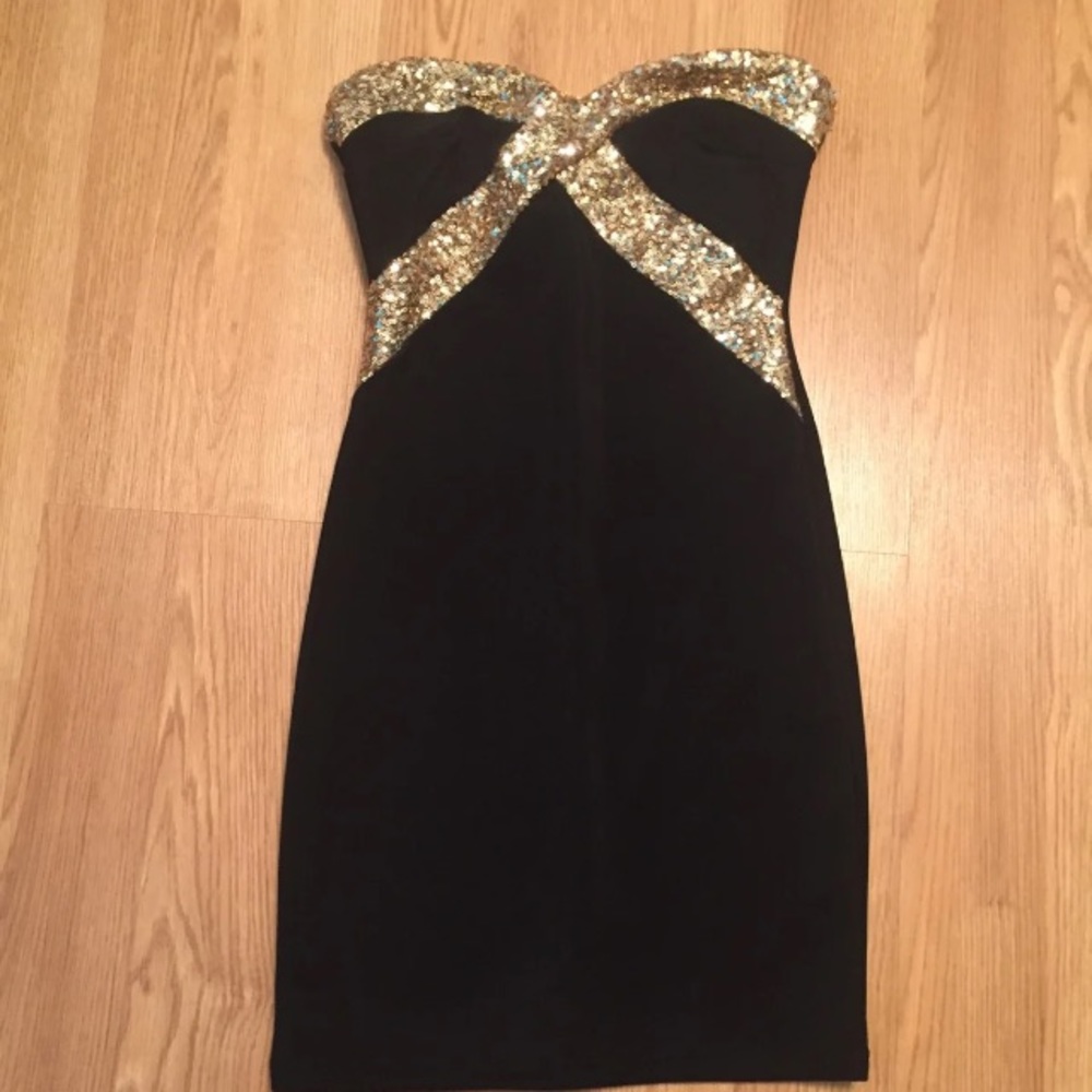 Women’s little black dress with gold sparkle